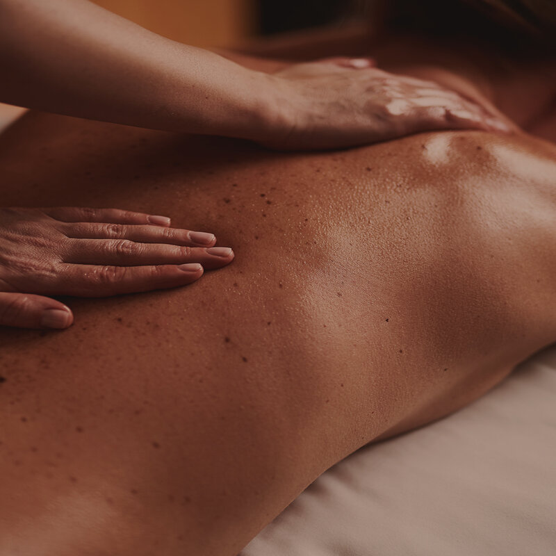 A person receiving a back massage.